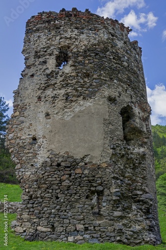 Medieval broken tower. The custom-house on Olt river in Carpathian mountains. photo