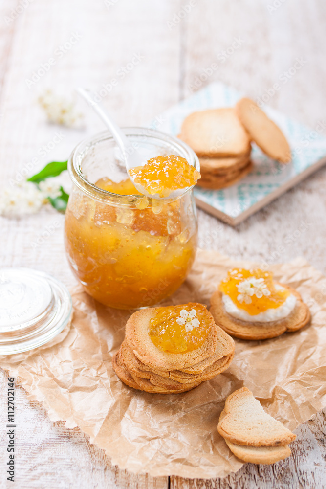 Fresh fruity juicy jam with figs in a jar with crackers and cottage cheese for breakfast, closeup Fresh fruity juicy jam with figs in a jar with crackers and cottage cheese for breakfast, closeup