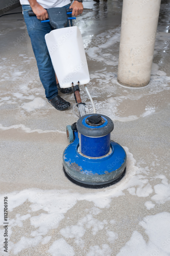 cleaning black granite floor with machine and chemical Stock Photo