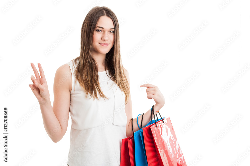 Fashion woman portrait with young shopaholic showing victory sig Fashion woman portrait with young shopaholic showing victory sig