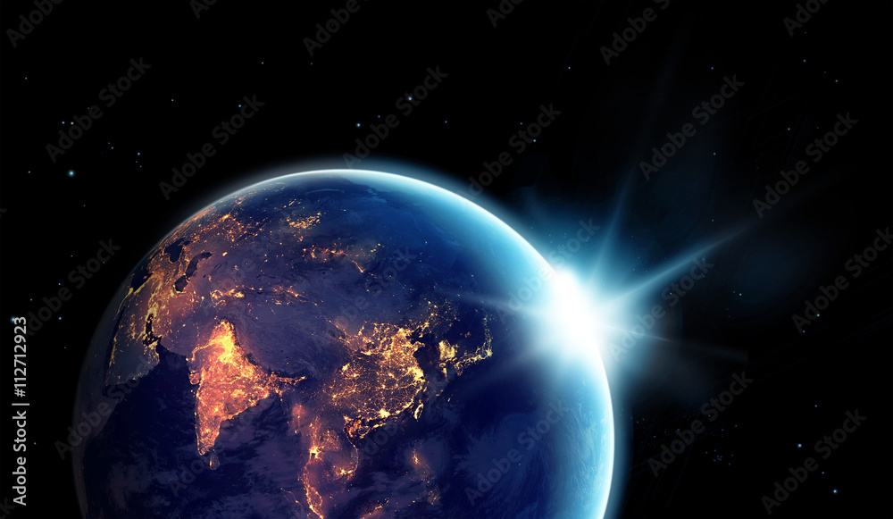 Fototapeta premium City lights at night in planet earth with sun rising