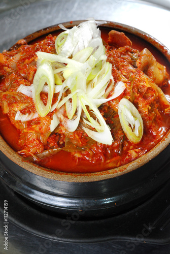 korean kimji soup in hot stone bowl photo