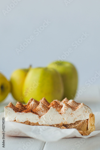 Apple pie with whipped cream covered by grated chocolate