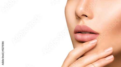 Perfect woman's sensual lips with fashion natural beige matte lipstick makeup