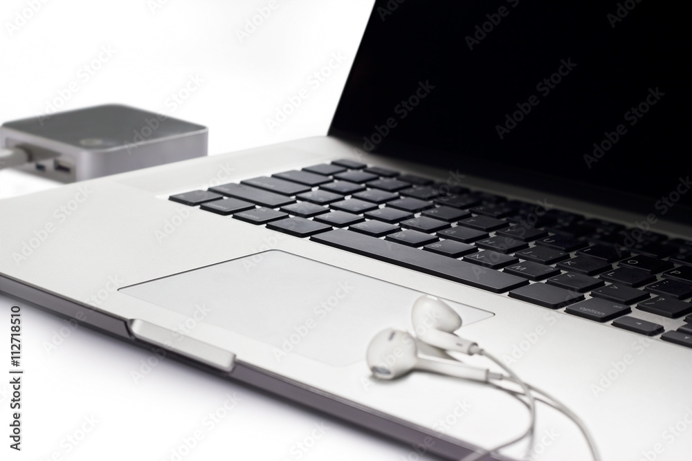 Laptop and earphone on white background Laptop and earphone on white background