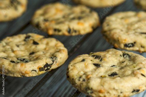 Tasty cookies with olives, rosemary and cheese