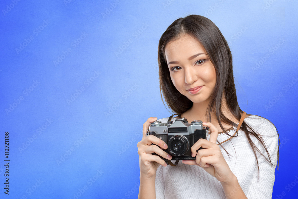 Woman using a retro photo camera