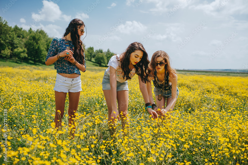 3 beautiful hippie girl in a field of yellow flowers 3 beautiful hippie girl in a field of yellow flowers