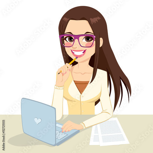 Beautiful pensive brunette office secretary woman wearing glasses typing on her computer and holding a pencil on her hand