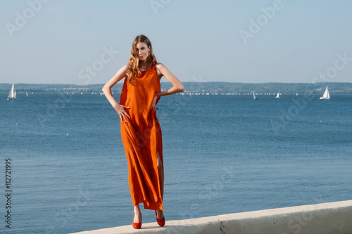 pretty girl on a pier in dress
