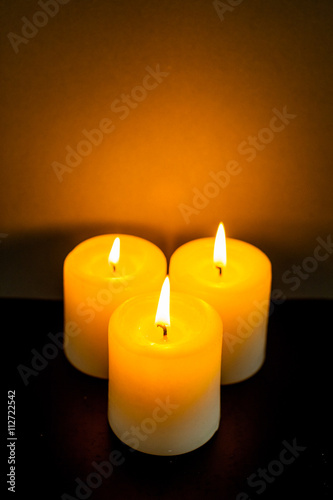 closeup to burning candles in darkness © fotofabrika