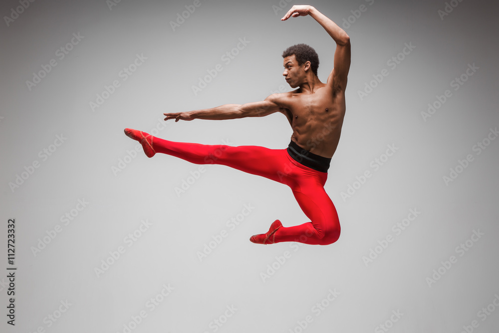 Obraz premium Young and stylish modern ballet dancer on gray background