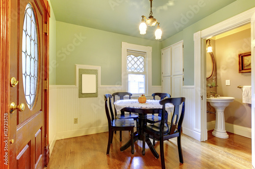 Small and cozy dining room with black wood table chair set and g