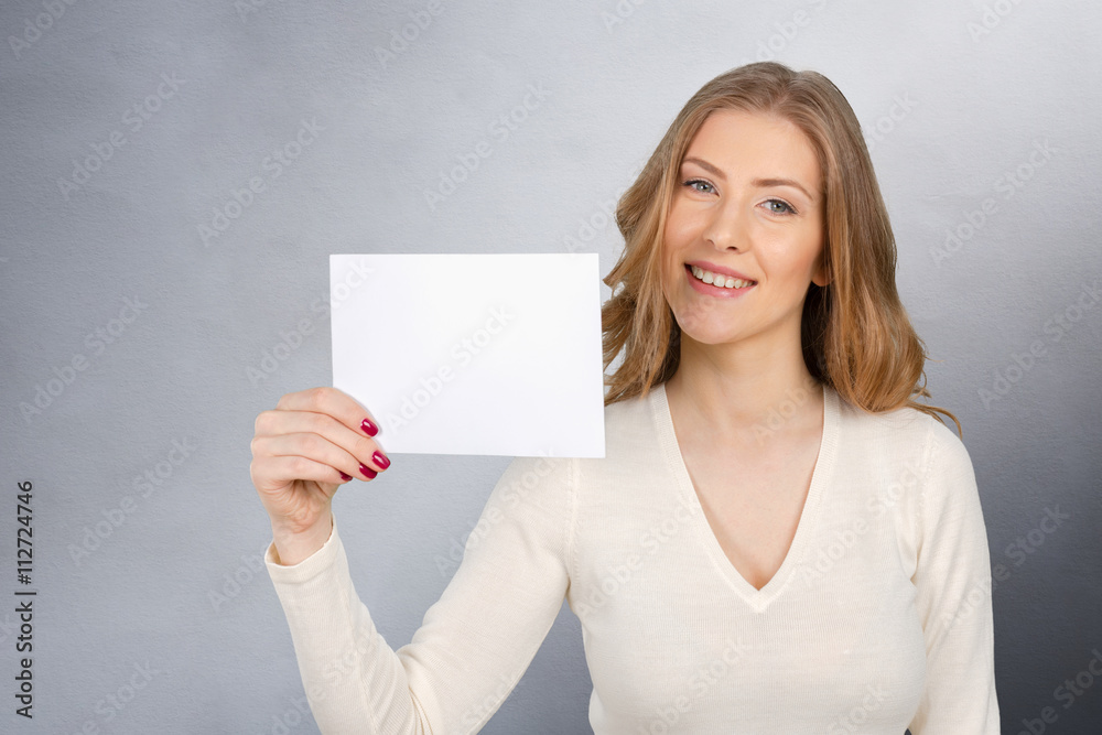 Businesswoman holding a blank business card Businesswoman holding a blank business card
