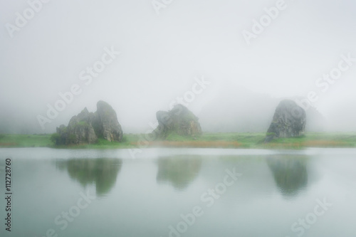 Lake in La Arboleda with some rocks photo