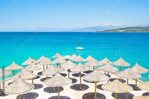 Sunshade umbrellas on the beautiful Ksamil beach, Albania.