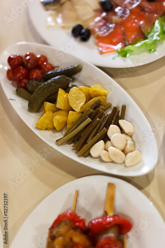 Pickled vegetables on plate on banquet table