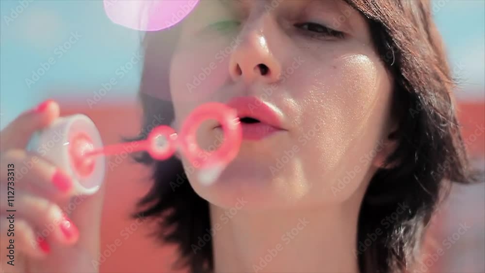 girl having fun making bubbles in slowmotion girl having fun making bubbles in slowmotion