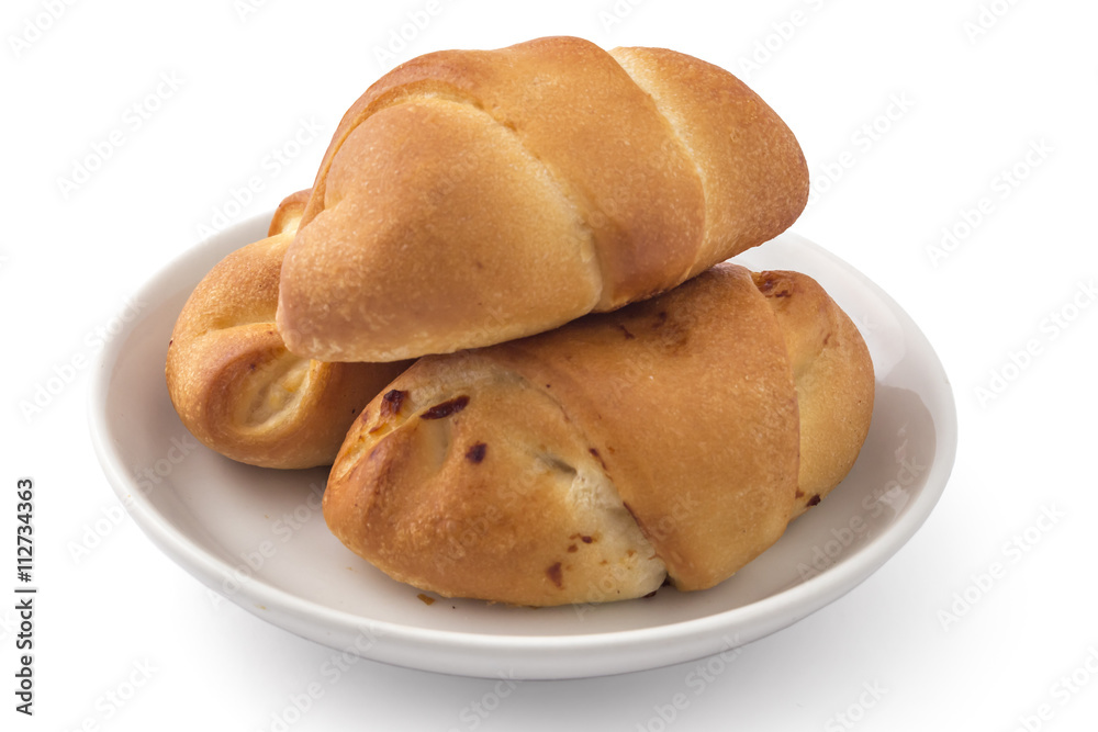 Fresh bavarian pastries rolls, kifla kiflice, on white plate, isolated on white background