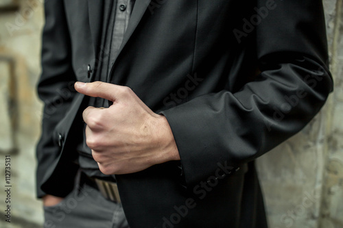 Close-up of unrecognizable man holding his jacket lapel © Framestock