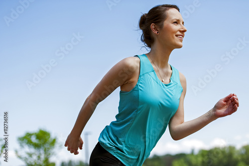 Fit woman jogging in park.