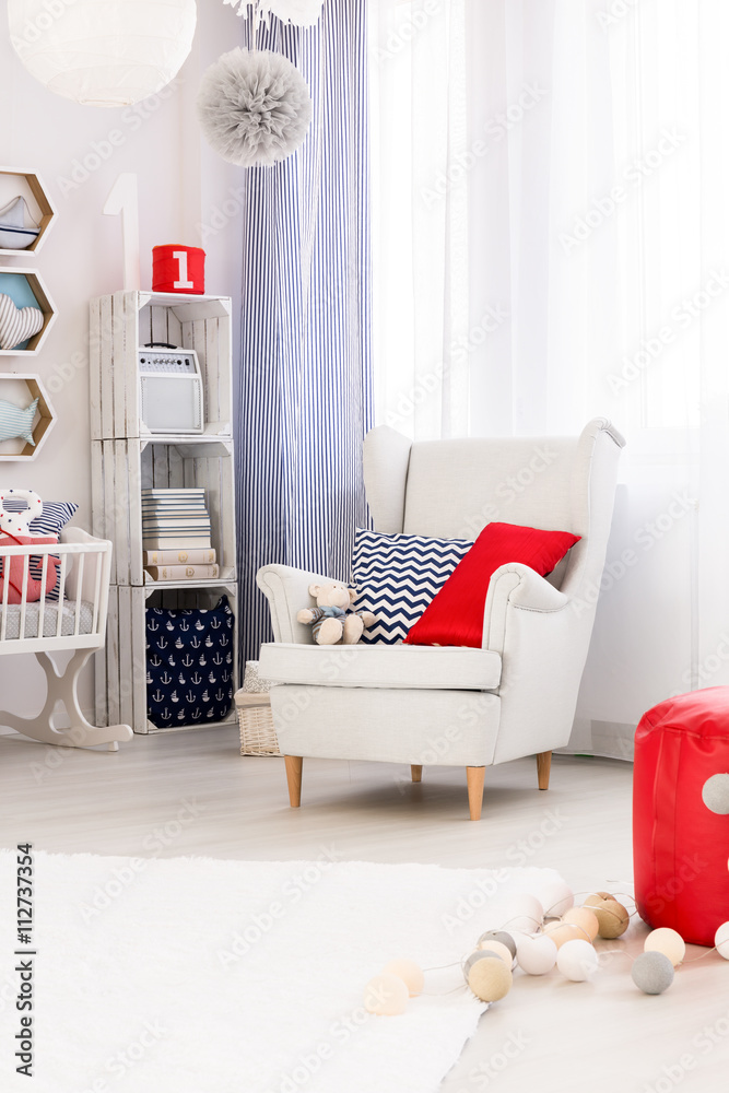 Φωτογραφία Child room in marine style with white furniture, comfortable armchair and stylis