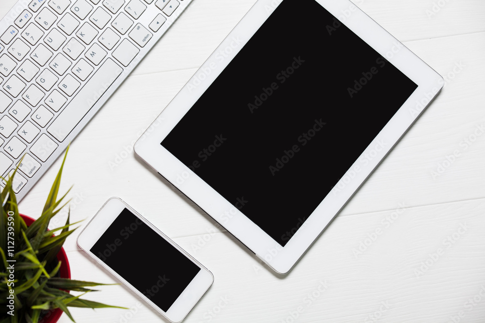 Keyboard with tablet, phone, business card on wooden table, top view Keyboard with tablet, phone, business card on wooden table, top view