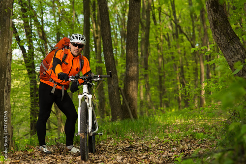 Cyclist Riding the Bike on a Trail in Summer Forest