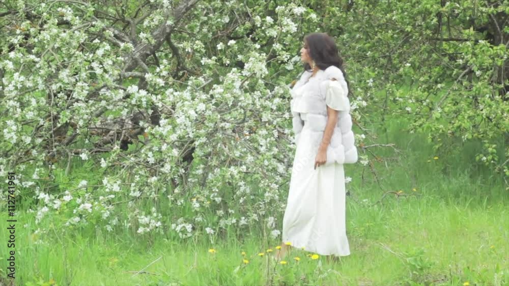 A beautiful dark-skinned woman in a white dress