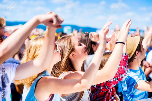 Teenagers at summer music festival having good time photo