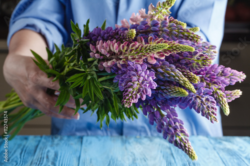 Woman with bouquet of wild lupin flowers