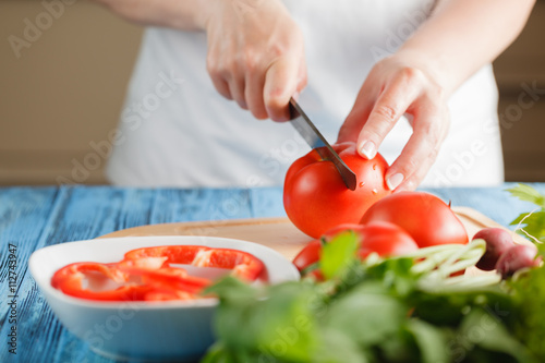 Fototapeta Naklejka Na Ścianę i Meble -  Diced tomatoes on a cutting board