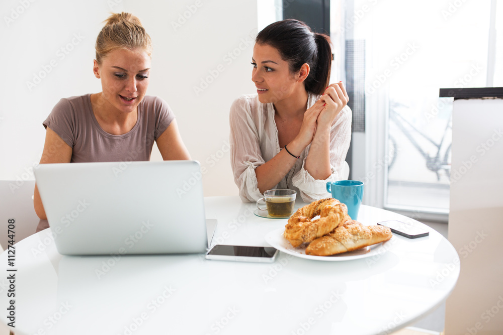 Two Female Friends Enjoying Breakfast At Home Together Two Female Friends Enjoying Breakfast At Home Together