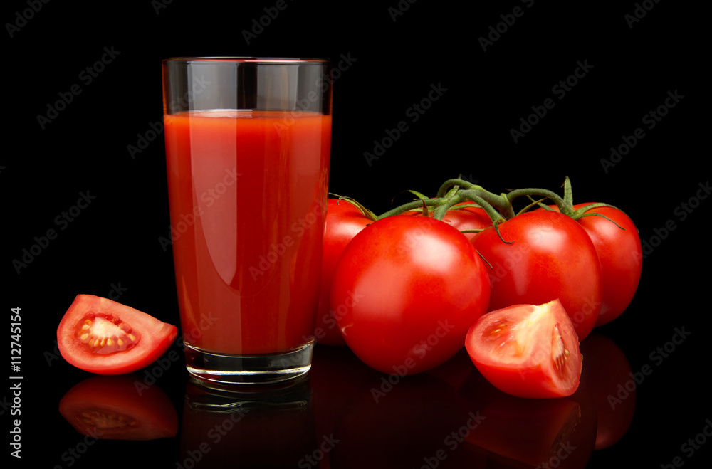Tomato juice with tomatoes,green twig on black Tomato juice with tomatoes,green twig on black