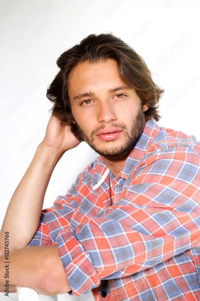 Serious young man with beard staring Serious young man with beard staring