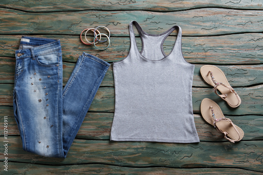 Jeans and gray tank top. Blue denim pants and sandals. Woman's brand ...