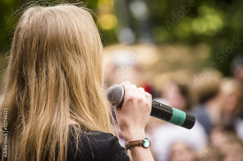 woman speaks into the microphone