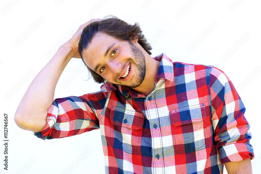 Smiling young man with hand in hair Smiling young man with hand in hair