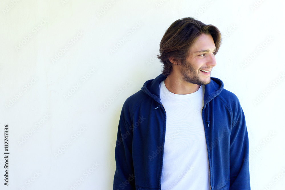 Smiling young man with beard looking away