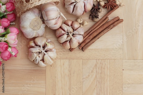 Garlic has health benefits on wood background.