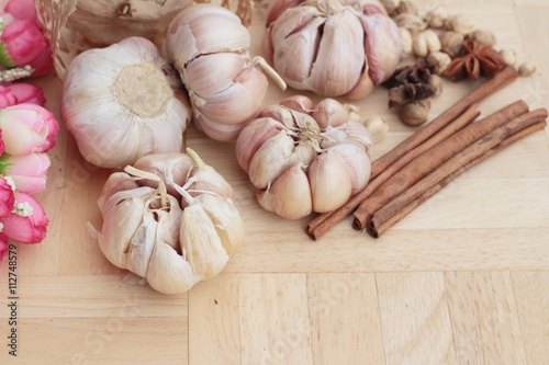 Garlic  has health benefits on wood background.