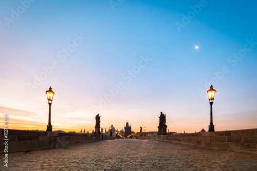 Charles Bridge at sunrise, Prague, Czech Republic. Dramatic statues and medieval towers.
