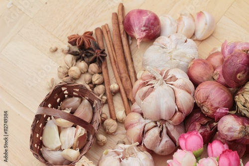 Shallot and garlic for cooking on wood background.