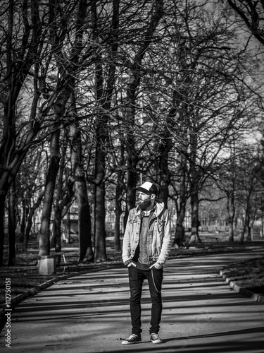 Handsome hipster, modern man in the park, black and white