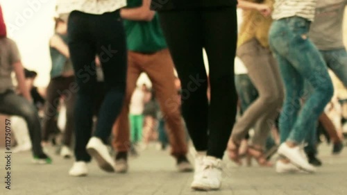 Couples dancing latina social dances in open air, defocused