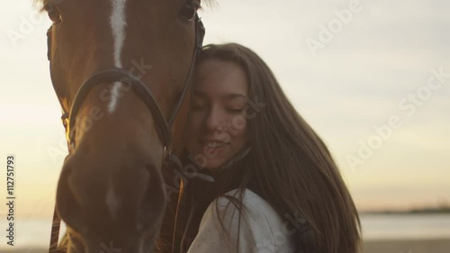 Young Girl Stroking and Hugging a Horse. Shot on RED Cinema Camera.