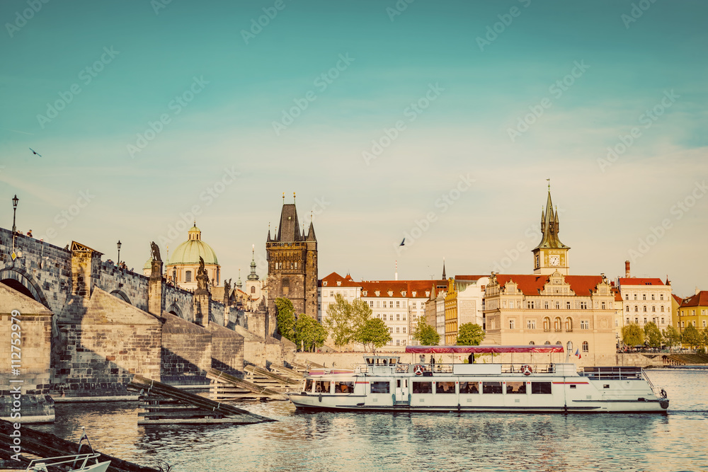 Obraz premium Prague, Czech Republic. Charles Bridge, boat cruise on Vltava river. Vintage
