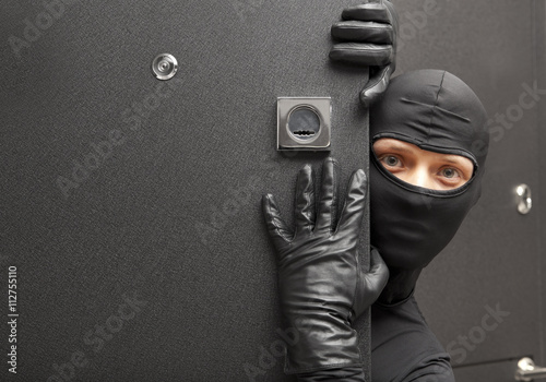 Ninja. Robber hiding behind a door