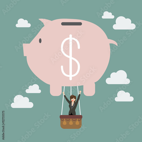 Business woman celebrating in piggy bank balloon