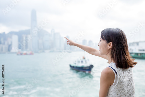 Woman finger point to the location in Hong Kong
